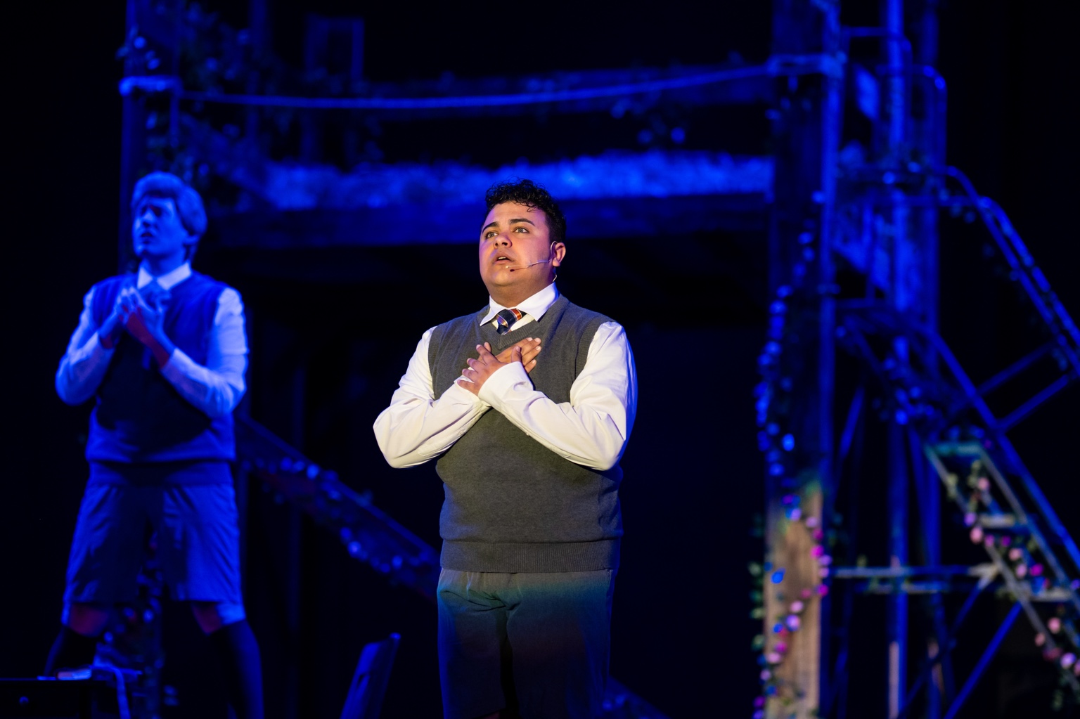 Garid Garcia singing under blue stage lighting