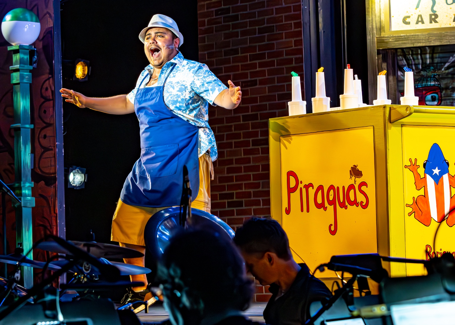 Garid Garcia performing at a piragua cart onstage